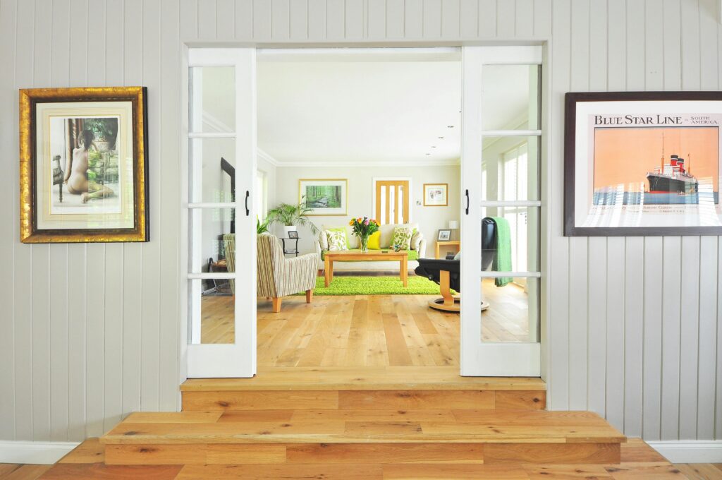 A bright and open living room showcasing pine floors laid by a flooring contractor