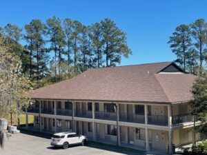 Two-story military lodging building at Merritt Field in South Carolina, showcasing the existing shingle roof structure before and after the NVA Contracting roofing project