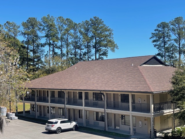 Two-story military lodging building at Merritt Field in South Carolina, showcasing the existing shingle roof structure before and after the NVA Contracting roofing project