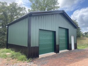 Exterior view of a commercial steel-frame warehouse building after construction, showing the completed warehouse.